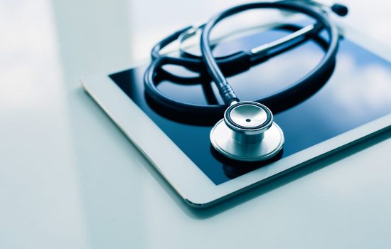 Medical Equipment On Table. Blue Stethoscope And Tablet On White Medical equipment on table. Blue stethoscope and tablet on white background.